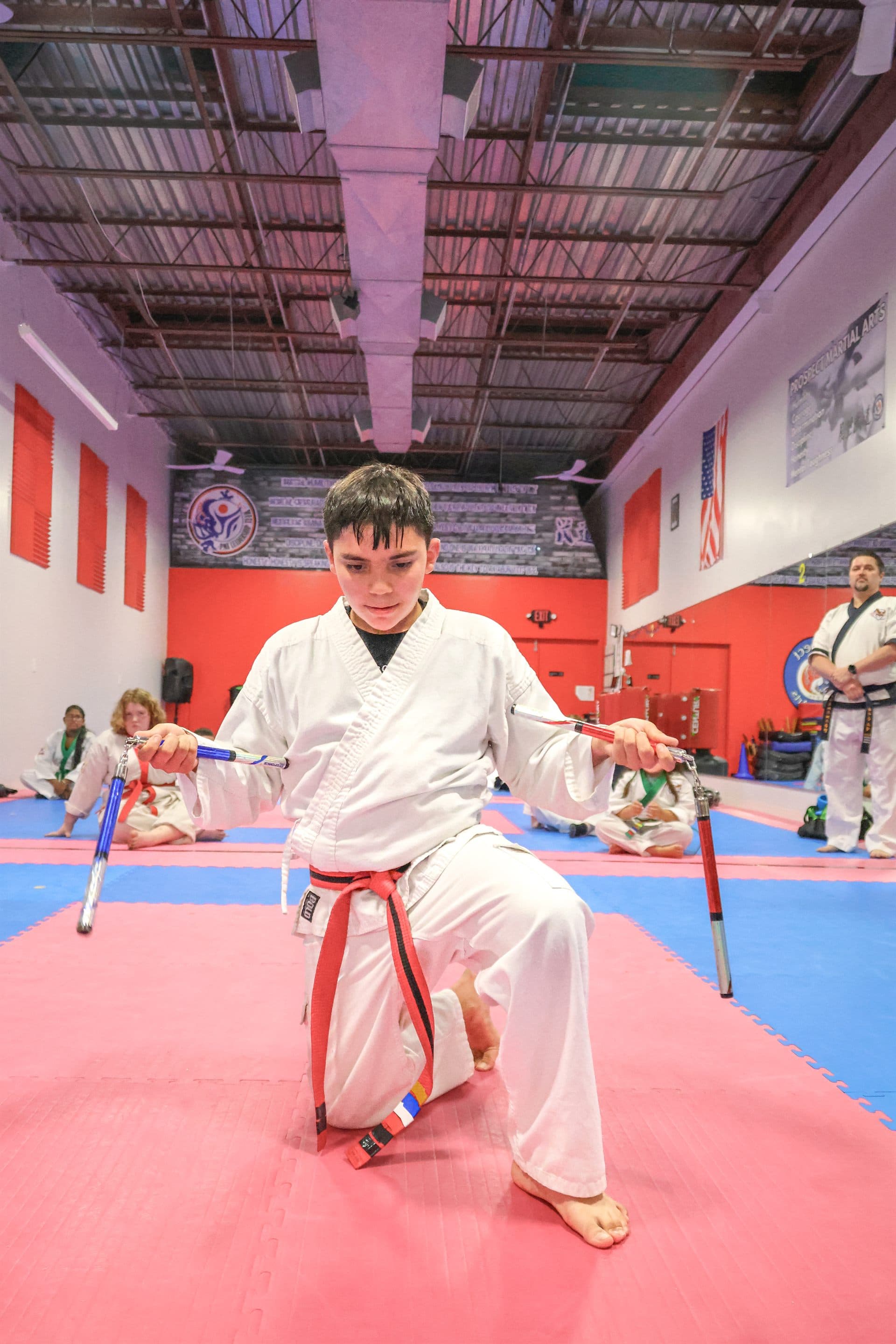 Student practicing nunchaku during class at Prospect Martial Arts